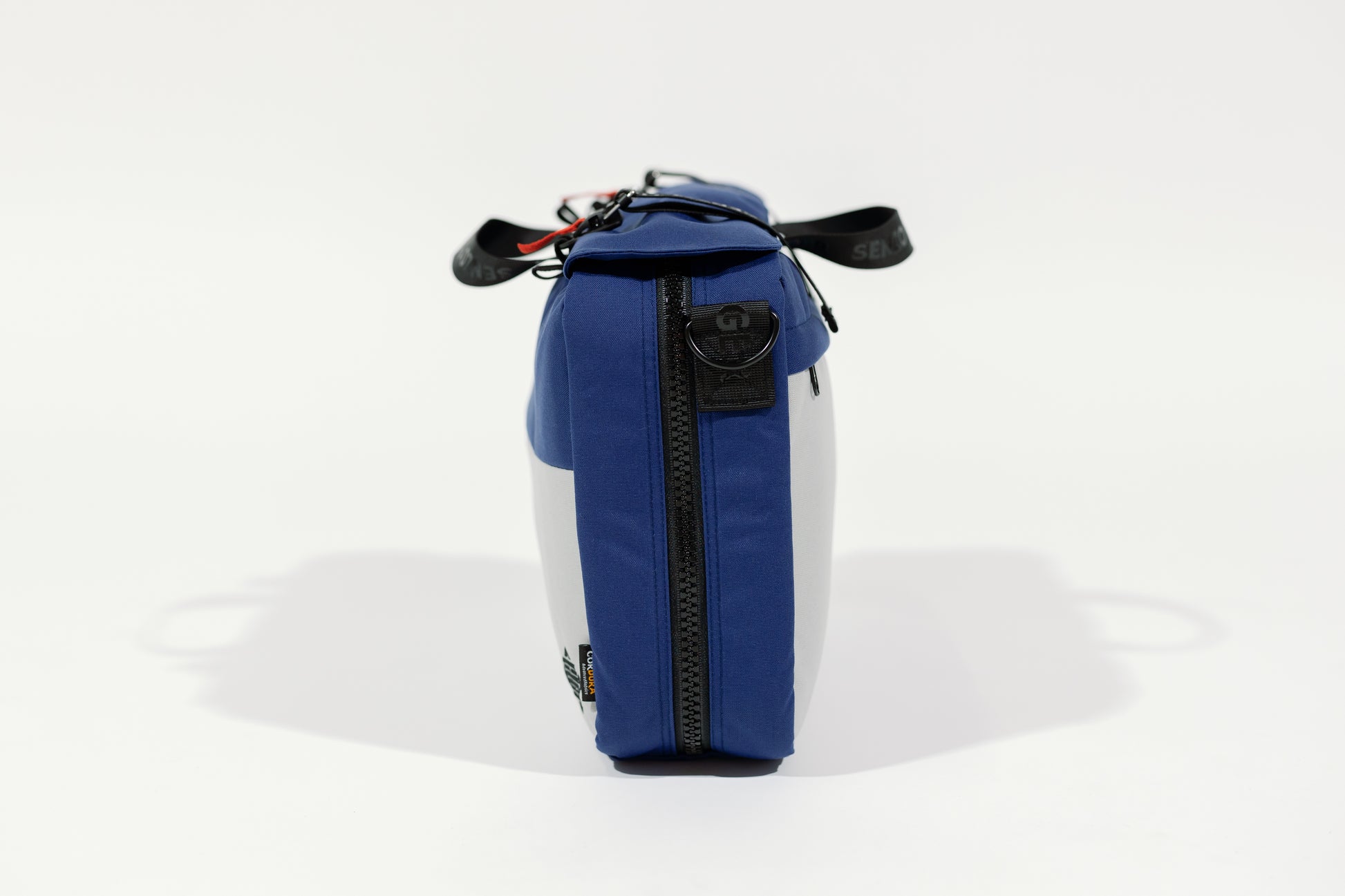 SIde view of the blue bag which is 4" thick