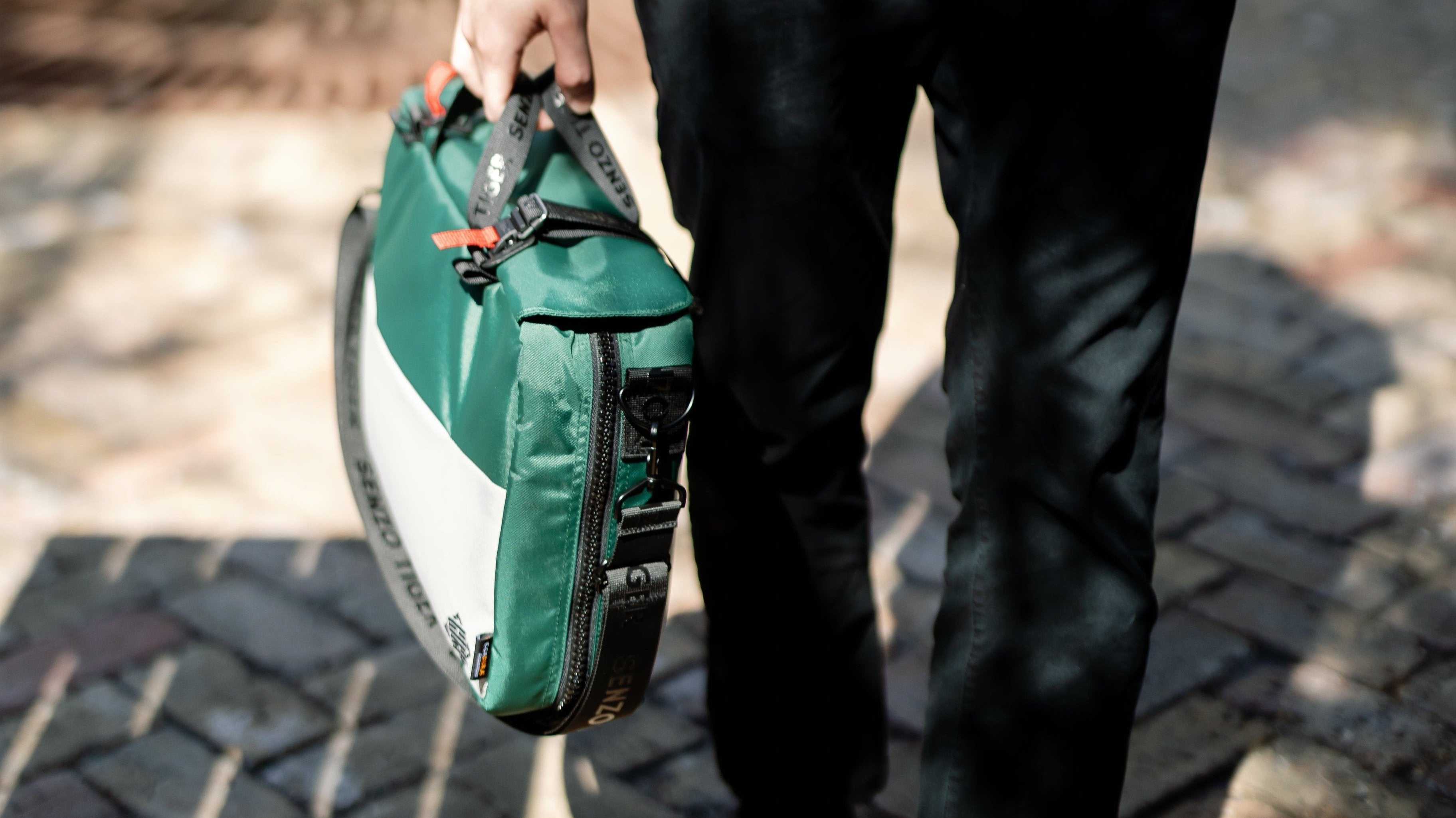 Man holding a green briefcase